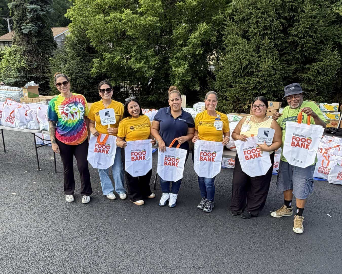 Volunteers distribute food to patients and community members during a food distribution event hosted by Cornerstone Family Healthcare and the Regional Food Bank in recognition of National Health Center Week at Cornerstone’s Kaplan Family Pavilion in Newburgh, N.Y.